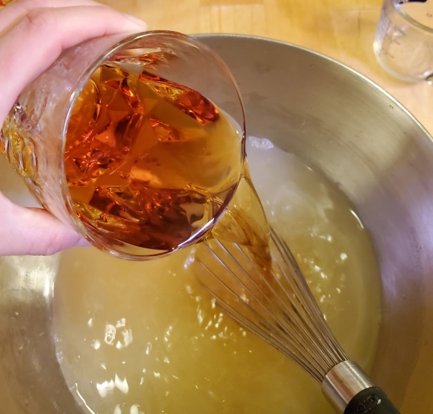 Adding cognac and rum to the fish house punch