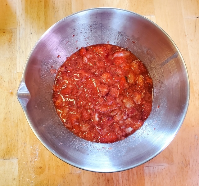 Syrupy strawberry mixture in bowl.