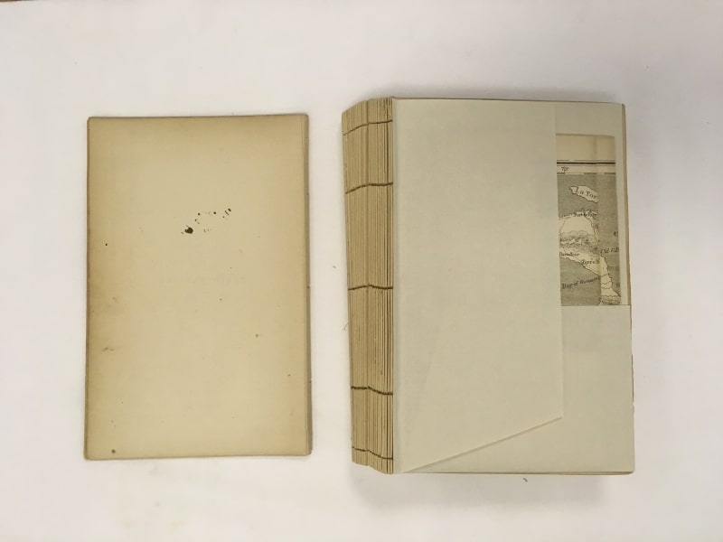 Map re-folded and placed inside pocket before re-sewing the text