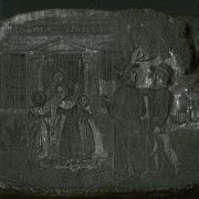 Two white men converse and follow a group of white women and children into a building with the sign Sunday School.