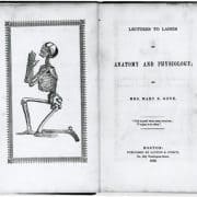 Book open to title page with facing illustration of a kneeling, praying skeleton