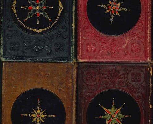 Back covers of Leavitt & Allen gift books with papier-mâché medallions.
