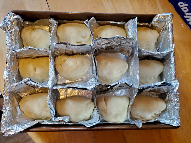 Image of the rolls of dough in Katie's improvised pan with lots of aluminum foil.