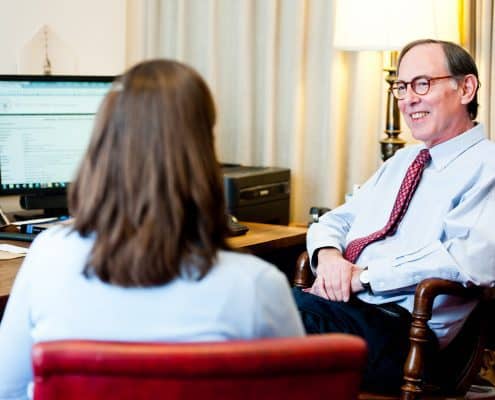 Fellow speaking with Librarian James N. Green in his office.