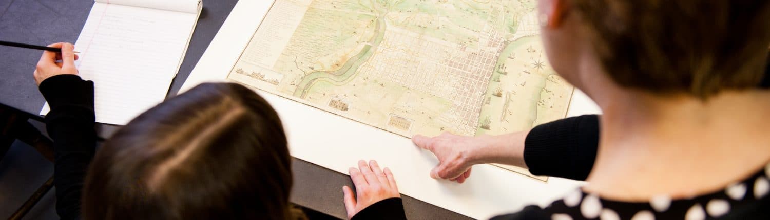 Sarah Weatherwax, Curator of Print and Photographs assisting a researcher in the Print Department Reading Room.