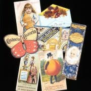 Trade cards depicting a butterfly, a little white girl holding a large bottle, a peach with arms and legs, a white baby, and a bird.