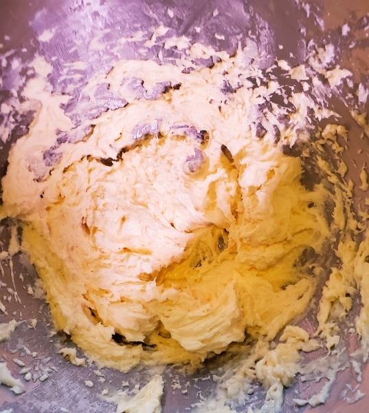 Adding eggs to butter and sugar