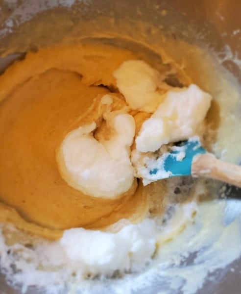 Folding the whipped egg whites into the other ingredients