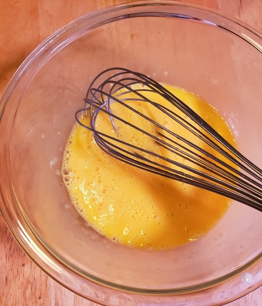 Beating the eggs with a whisk Beating the eggs with a whisk