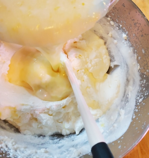 Folding the lemon mixture into the whipped cream Folding the lemon mixtu