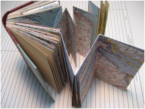 Sampler book laid out to show unique folding pattern.