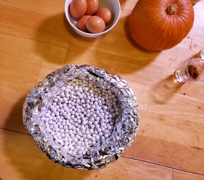 Crust with pie weights ready for blind bake Crust with pie weights ready for blind bake